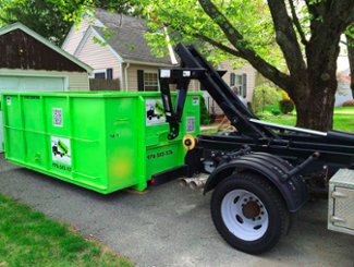 Hooklift Truck Picking Up Roll Off Dumpster